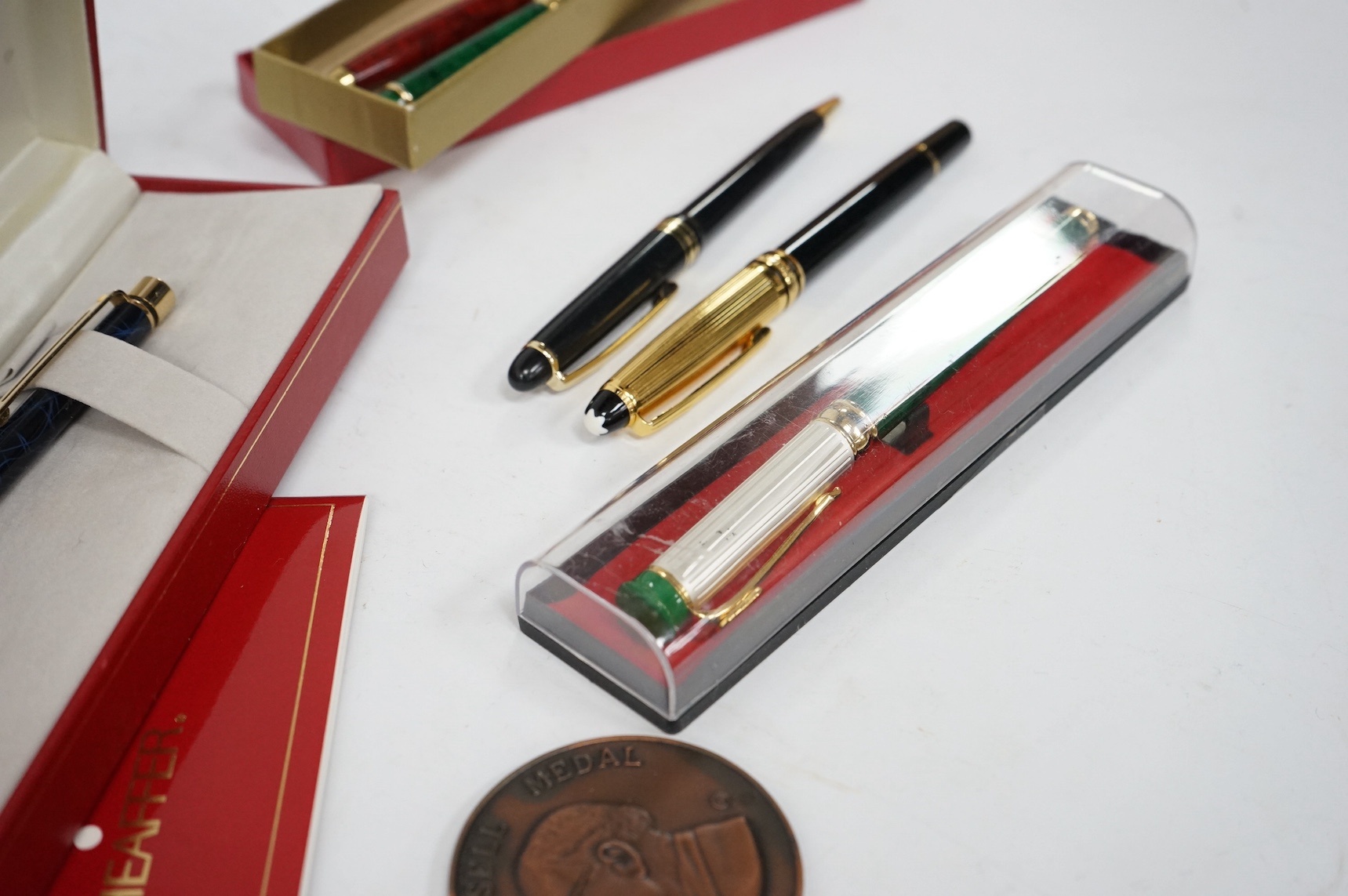 A collection of various pens and a H.N. Ansell medal. Condition - varies